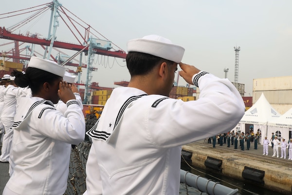 Sailors aboard the Arleigh Burke-class guided-missile destroyer USS John Finn (DDG 113) man the rails during a sea and anchor detail in Jakarta, Indonesia, Aug. 25.