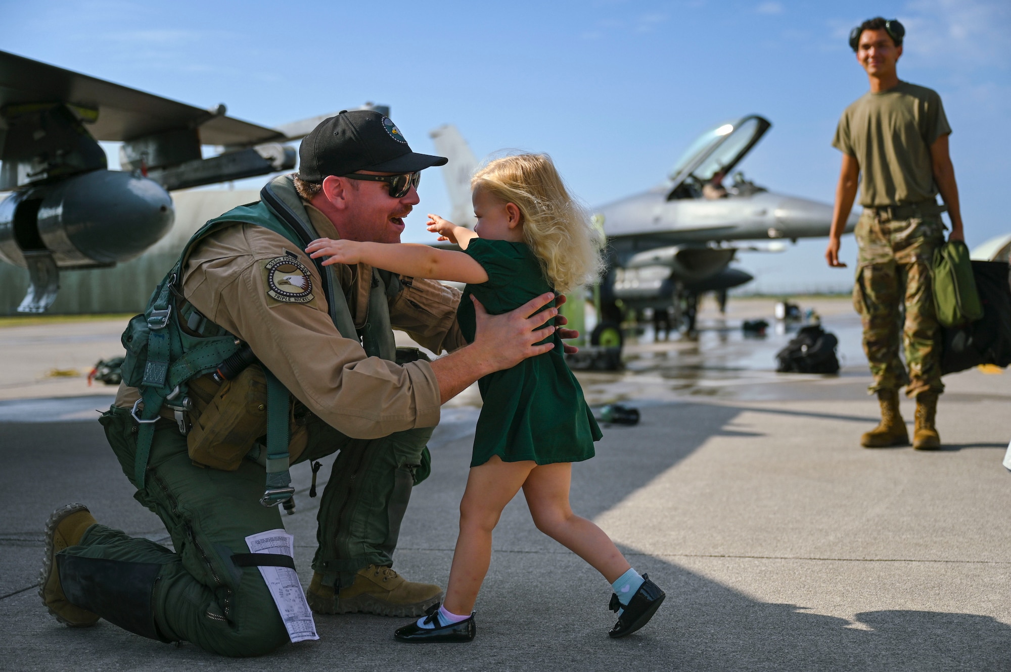 Airman embracing his family