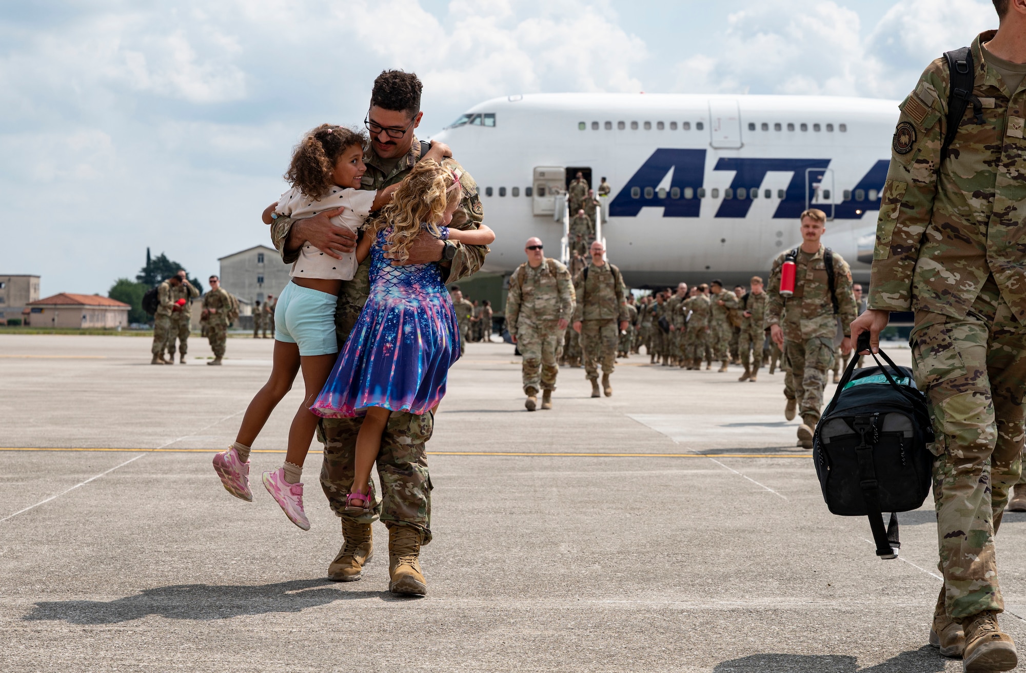 Airman hugging family members