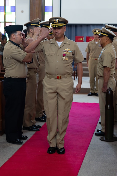 U.S. Navy Capt. Joseph Piansay, center, the deputy surgeon of III Marine Expeditionary Force, is piped ashore during his retirement ceremony at Kadena Air Base, Okinawa, Japan, Aug. 29, 2025.  Piansay, a native of the Philippines, was honored for 35 years of active-duty service, beginning his career in 1990 as a corpsman at Naval Base Subic Bay, Philippines, before receiving a commission as an officer.  (U.S. Marine Corps photo by Lance Cpl. Kindsey Calvert)