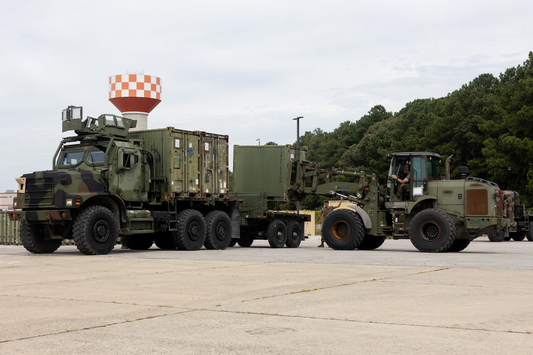 U.S. Marines with 2nd Medical Battalion and Combat Logistics Battalion 24, both with 2nd Marine Logistics Group, load equipment onto a medium replacement tactical vehicle during a quadruple container movement at Marine Corps Base Camp Lejeune, North Carolina, Aug. 28, 2025. The logistical movement supported the re-embarkation of medical equipment back to their parent units to ensure equipment and supplies are restocked and inspected following operations. (U.S. Marine Corps photo by Lance Cpl. Franco Lewis)