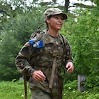 Tech. Sgt. Amber Martine of the 157th Air Refueling Wing, New Hampshire Air National Guard, dashes through Concord’s Karner blue butterfly conservation easement during a 30-kilometer Norwegian Foot March on June 14, 2025.