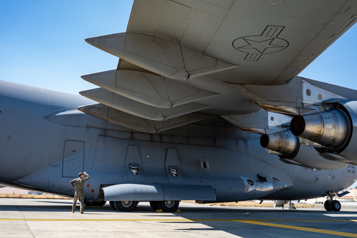 Capt. Kyle Mackey, 21st Airlift Squadron C-17 Globemaster III flight instructor, performs a walkaround of a C-17 prior to takeoff at Travis Air Force Base, Calif., Aug. 27, 2025. The pre-flight walkaround is a mandatory, methodical procedure that covers all critical exterior components, checking for general wear, damage and leaks. (U.S. Air Force photo by Senior Airman Robert Nichols)