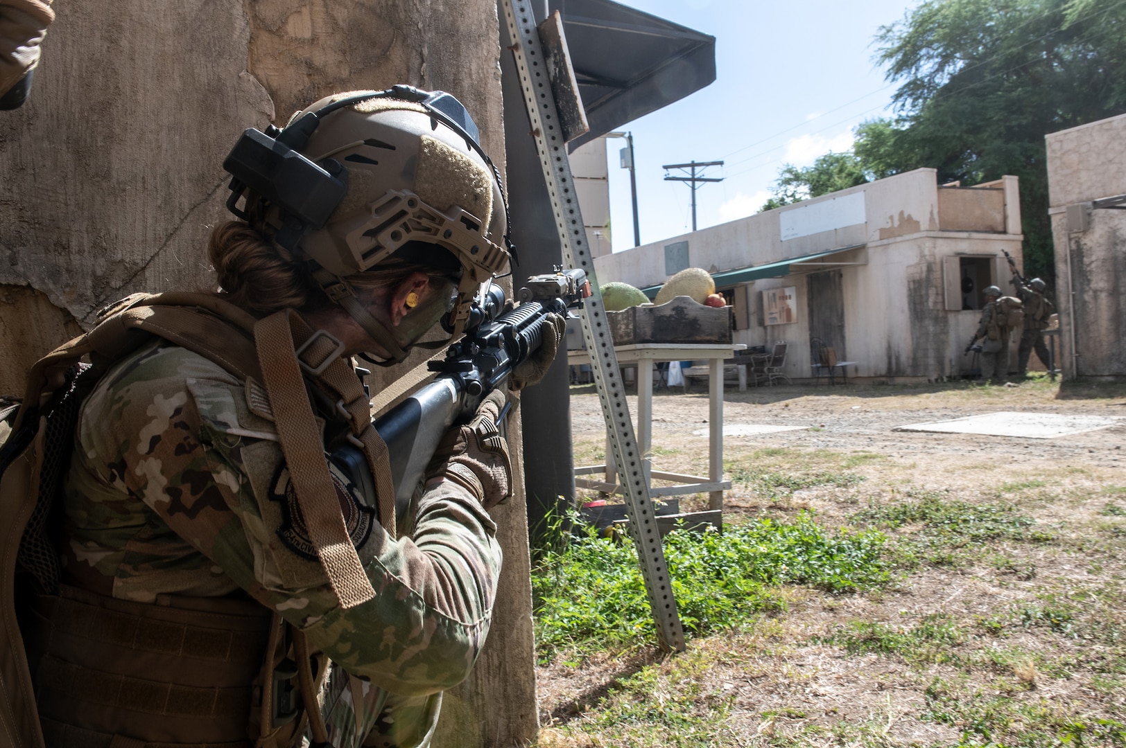 U.S. Air Force Airman Isabel Velazquez, 154th Civil Engineer Squadron emergency management specialist, engages in a simulated combat scenario with U.S. Marines during exercise Toxic Swell Aug. 21, 2025, at Marine Corps Training Area, Bellows Air Force Station, Hawaii.