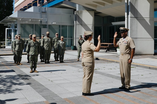 SILVER SPRING, Md. (Sept. 3, 2025) Master Chief Hospital Corpsman Phillip Jean-Gilles, command master chief (CMC) of Naval Medical Research Command (NMRC), recites the oath of enlistment, administered by Lt. Sara Tuck, during a reenlistment ceremony. Immediately following his reenlistment, Jean-Gilles relinquished his position as CMC to Master Chief Hospital Corpsman Christopher Cariss during a change of office ceremony. NMRC, headquarters of Navy Medicine Research & Development, is engaged in a broad spectrum of activity from basic science in the laboratory to field studies in austere and remote areas of the world to investigations in operational environments. In support of Navy, Marine Corps and joint U.S. warfighter health, readiness and lethality, researchers study infectious diseases, biological warfare detection and defense, combat casualty care, environmental health concerns, aerospace and undersea medicine, operational mission support and epidemiology. (U.S. Navy photo by Aleece Williams/Released)