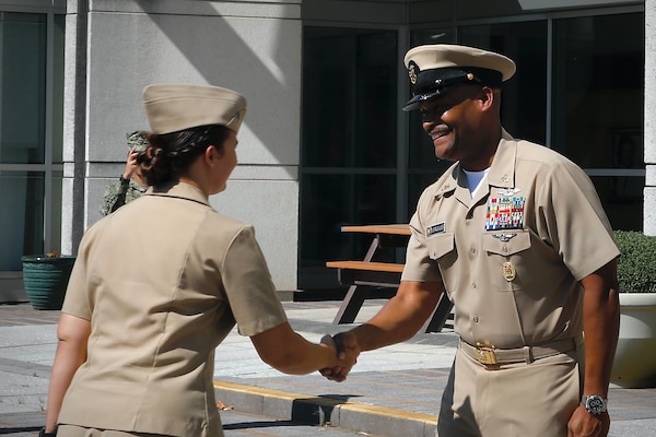 SILVER SPRING, Md. (Sept. 3, 2025) Master Chief Hospital Corpsman Phillip Jean-Gilles, command master chief (CMC) of Naval Medical Research Command (NMRC), thanks Lt. Sara Tuck for administering his oath of reenlistment at his reenlistment ceremony. Immediately following his reenlistment, Jean-Gilles relinquished his position as CMC to Master Chief Hospital Corpsman Christoper Cariss during a change of office ceremony. NMRC, headquarters of Navy Medicine Research & Development, is engaged in a broad spectrum of activity from basic science in the laboratory to field studies in austere and remote areas of the world to investigations in operational environments. In support of Navy, Marine Corps and joint U.S. warfighter health, readiness and lethality, researchers study infectious diseases, biological warfare detection and defense, combat casualty care, environmental health concerns, aerospace and undersea medicine, operational mission support and epidemiology. (U.S. Navy photo by Aleece Williams/Released)