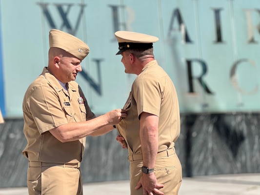 SILVER SPRING, Md. (Sept. 3, 2025) Capt. Eric Welsh, commander, Naval Medical Research Command (NMRC) pins the Command Master Chief (CMC) Identification Badge on Master Chief Hospital Corpsman Christopher Cariss during a change of office ceremony, in which Cariss relieved Master Chief Hospital Corpsman Phillip Jean-Gilles as NMRC’s CMC. NMRC, headquarters of Navy Medicine Research & Development, is engaged in a broad spectrum of activity from basic science in the laboratory to field studies in austere and remote areas of the world to investigations in operational environments. In support of Navy, Marine Corps and joint U.S. warfighter health, readiness and lethality, researchers study infectious diseases, biological warfare detection and defense, combat casualty care, environmental health concerns, aerospace and undersea medicine, operational mission support and epidemiology. (U.S. Navy photo by Tommy Lamkin/Released)