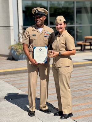 SILVER SPRING, Md. (Sept. 3, 2025) Master Chief Hospital Corpsman Phillip Jean-Gilles, command master chief (CMC) of Naval Medical Research Command (NMRC), stands alongside Lt. Sara Tuck who administered his oath of reenlistment, following his reenlistment ceremony. Immediately the ceremony, Jean-Gilles relinquished his position as CMC to Master Chief Hospital Corpsman Christopher Cariss during a change of office ceremony. NMRC, headquarters of Navy Medicine Research & Development, is engaged in a broad spectrum of activity from basic science in the laboratory to field studies in austere and remote areas of the world to investigations in operational environments. In support of Navy, Marine Corps and joint U.S. warfighter health, readiness and lethality, researchers study infectious diseases, biological warfare detection and defense, combat casualty care, environmental health concerns, aerospace and undersea medicine, operational mission support and epidemiology. (U.S. Navy photo by Tommy Lamkin/Released)
