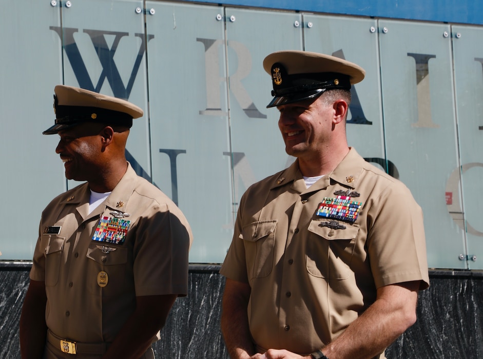 SILVER SPRING, Md. (Sept. 3, 2025) Master Chief Hospital Corpsman Phillip Jean-Gilles, command master chief (CMC) of Naval Medical Research Command (NMRC), stands alongside incoming Master Chief Cariss, before responsibility and authority is transferred. Immediately following his reenlistment, Jean-Gilles relinquished his position as CMC to Master Chief Hospital Corpsman Christopher Cariss during a change of office ceremony. NMRC, headquarters of Navy Medicine Research & Development, is engaged in a broad spectrum of activity from basic science in the laboratory to field studies in austere and remote areas of the world to investigations in operational environments. In support of Navy, Marine Corps and joint U.S. warfighter health, readiness and lethality, researchers study infectious diseases, biological warfare detection and defense, combat casualty care, environmental health concerns, aerospace and undersea medicine, operational mission support and epidemiology. (U.S. Navy photo by Aleece Williams/Released)