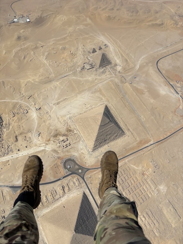 A U.S. Service Member admires the Great Pyramids of Giza from above during Military Free Fall (MFF) practice in Giza, Egypt on Aug. 27, 2025. Multinational operations and exercises, including BRIGHT STAR 25, increase the ability of our collective partners to operate in a joint, high-intensity environment, improving readiness, responsiveness, and interoperability. (Courtesy Photo)