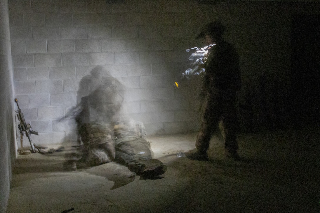 U.S. Marine Corps Lance Cpl. Darrian Davidson, a rifleman with 1st Battalion, 1st Marine Regiment, 1st Marine Division, holds security during tactical site exploitation after conducting a raid at Camp Pendleton, California, Aug. 21, 2025. The Raid Branch of Expeditionary Training Group provides relevant and realistic training to Marines and small-unit leaders in mission-essential tasks, including close-quarters battle and breaching, to prepare units for deployments. (U.S. Marine Corps photo by Sgt. Michael Virtue)