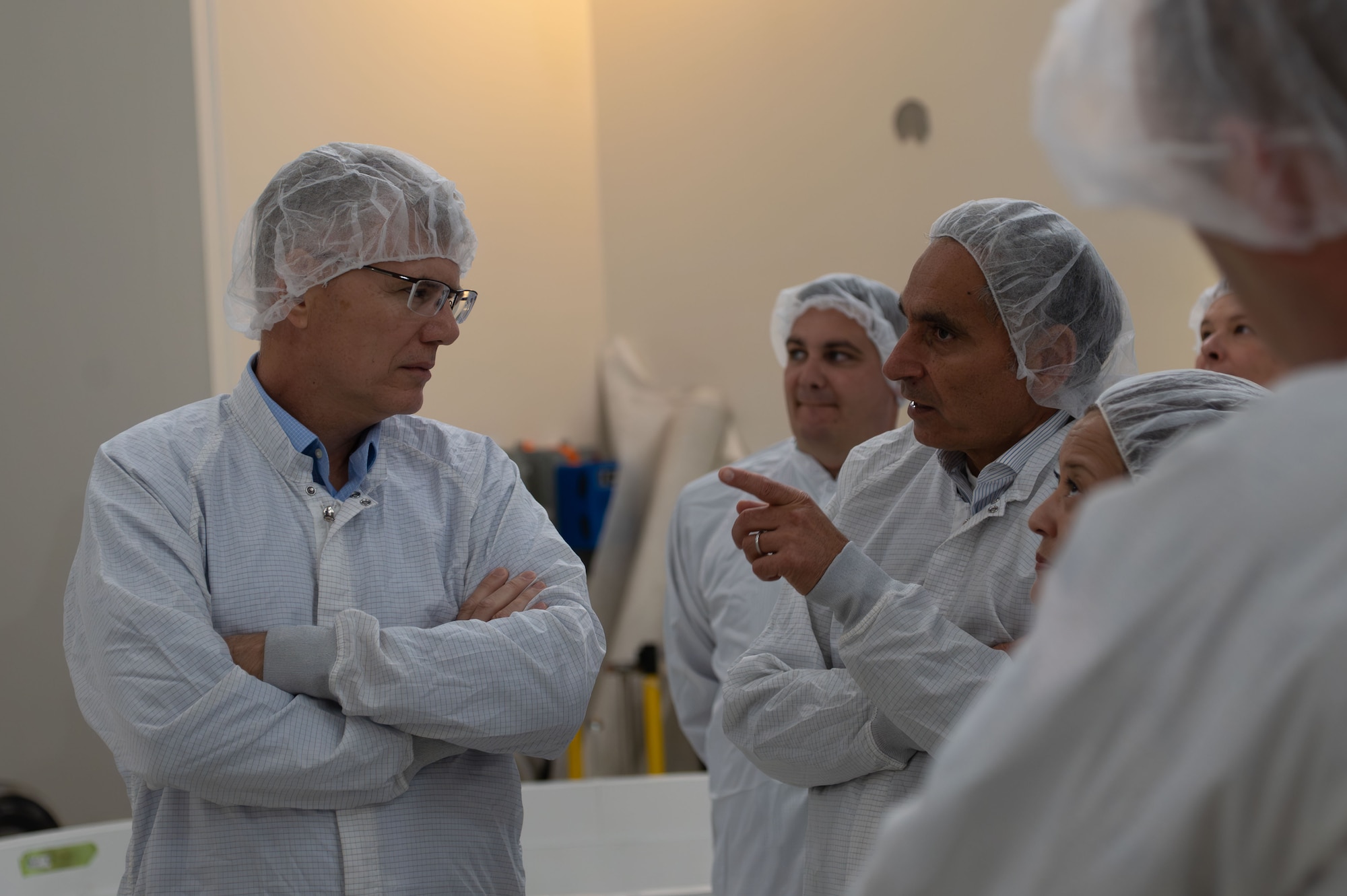 Secretary of the Air Force Troy Meink talks with leadership about the Space Development Agency’s Tranche 1 mission in a satellite processing facility at Vandenberg Space Force Base, Calif., Aug. 28, 2025. During the visit, Meink received a strategic overview of Vandenberg’s mission and its role in advancing U.S. interests in space. Tranche 1 is slated to launch from the Vandenberg SFB spaceport no earlier than Sept. 10. This launch will carry the first 21 of 154 Tranche 1 satellites that will deliver next-gen capability to the joint warfighter to support terrestrial missions through the Proliferated Warfighter Space Architecture  (U.S. Air Force photo by Staff Sgt. Daekwon Stith)