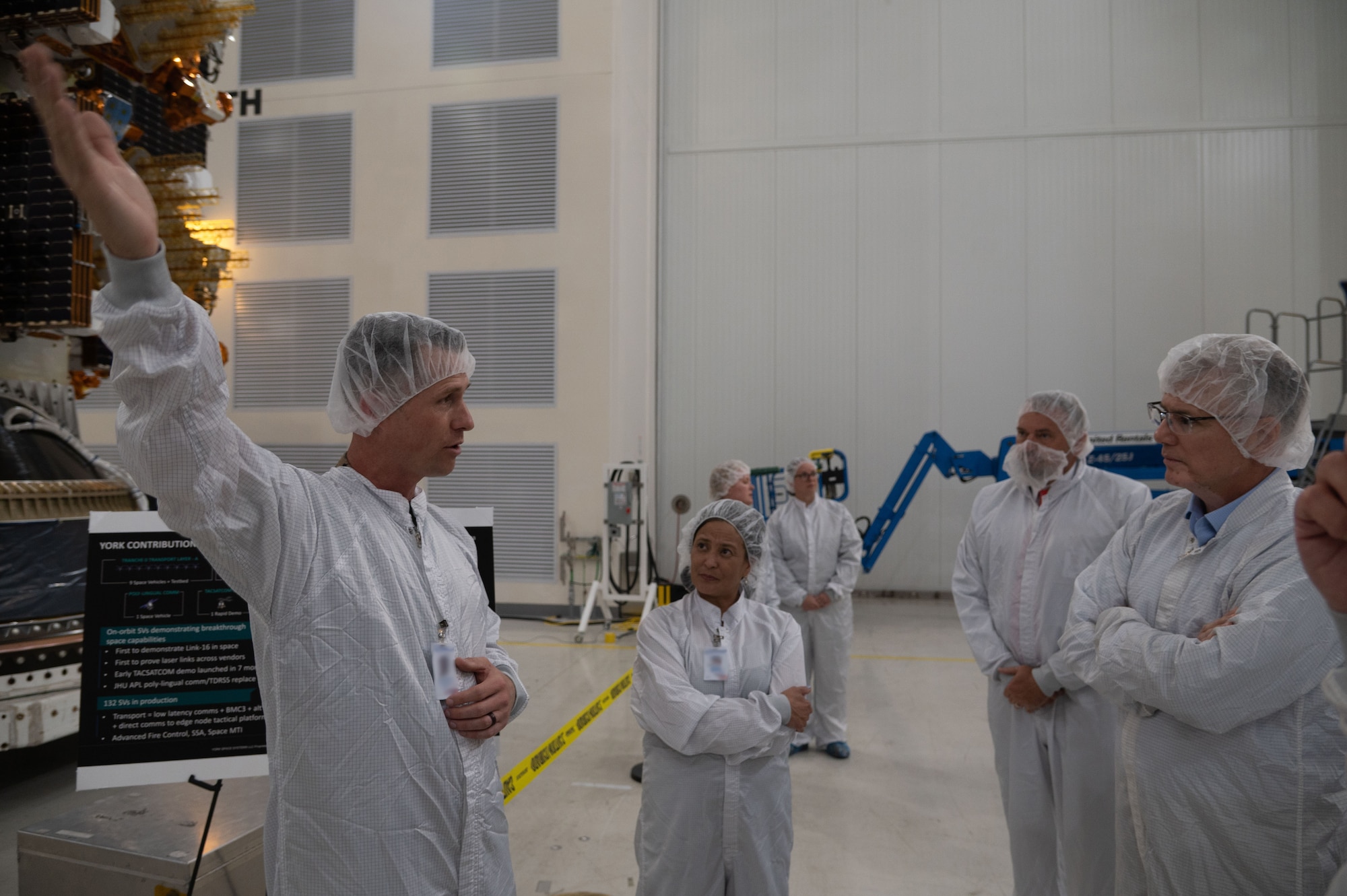 Secretary of the Air Force Troy Meink learns more about the Space Development Agency’s Tranche 1 satellites at a satellite processing facility at Vandenberg Space Force Base, Calif., Aug. 28, 2025. The launch of Tranche 1, which is slated to take place no earlier than Sept. 10,  will carry the first 21 of 154 Tranche 1 satellites to create a mesh network of optically-connected satellites focused on tactical data delivery to the warfighter at “the edge,” tracking and targeting for advanced missile threats, and beyond-line-of-sight targeting for time sensitive or mobile targets. (U.S. Air Force photo by Staff Sgt. Daekwon Stith)