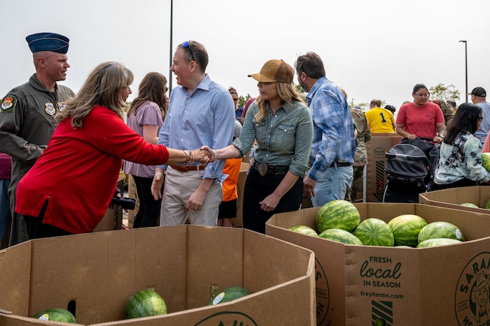 Sarah Frey, Frey Farms CEO, right, talks with a member of Team Scott during a ceremony.