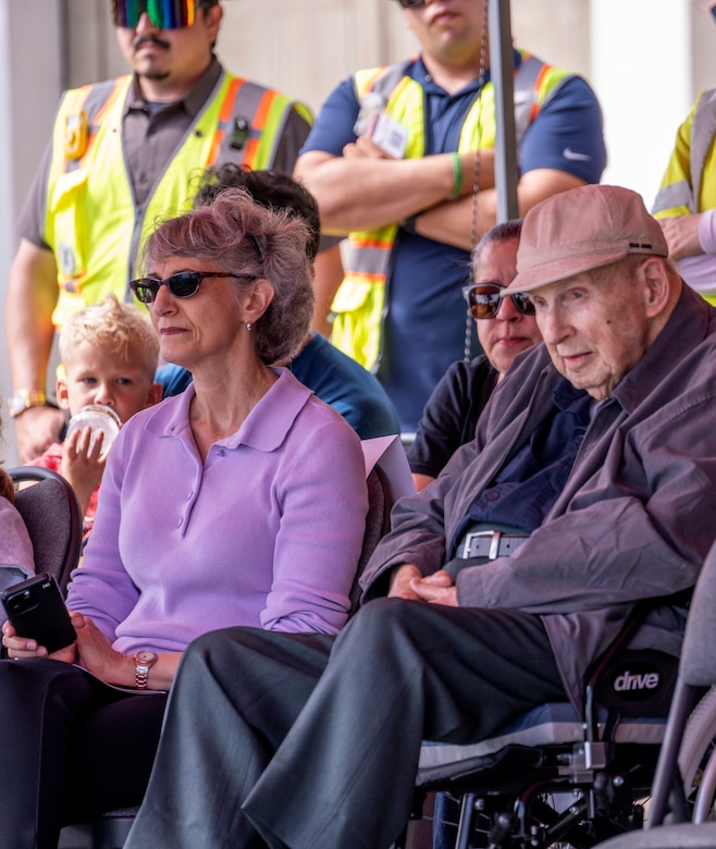 Property owner Noland West, right, and his daughter Eryn, foreground-left, join fellow community members and representatives from the U.S. Army Corps of Engineers, FEMA, California Governor’s Office of Emergency Services, Los Angeles County and the City of Los Angeles during an Aug. 26 milestone event marking the start of debris removal for the last opt-in private property in the Pacific Palisades fire recovery area in Los Angeles.