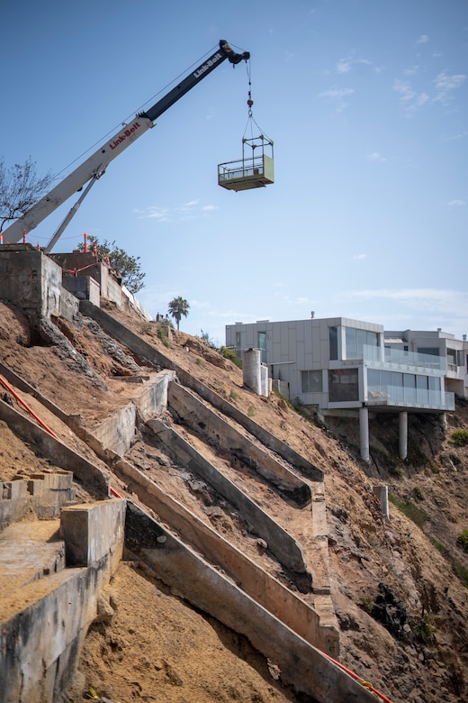 Work pauses Aug. 26 shortly before a milestone event marking the start of debris removal for the last opt-in private property in the Pacific Palisades fire recovery area in Los Angeles.