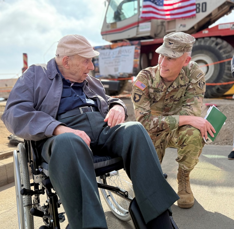 Col. Andrew Baker, commander of the U.S. Army Corps of Engineers Los Angeles District, right, talks with Noland West, whose property was the last opt-in private property slated for debris removal, during a milestone event Aug. 26 in the Pacific Palisades neighborhood of Los Angeles.
