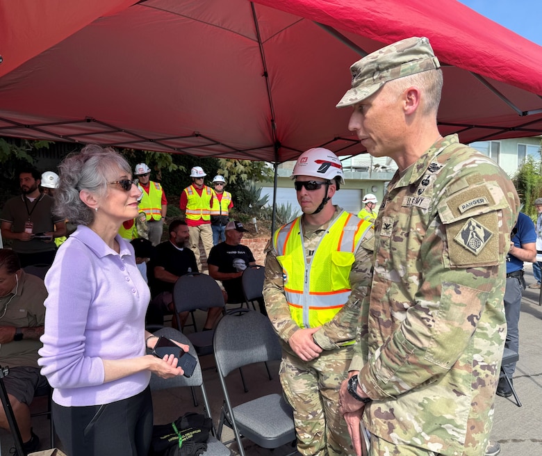 Eryn West, daughter of Noland West, whose property has been designated as the last opt-in private property in the Pacific Palisades neighborhood of Los Angeles to be slated for debris removal by the U.S. Army Corps of Engineers, talks with Col. Andrew Baker, Los Angeles District commander, and Capt. Zachary Bailey, with the USACE Recovery Field Office, during the Aug. 26 event marking the milestone.