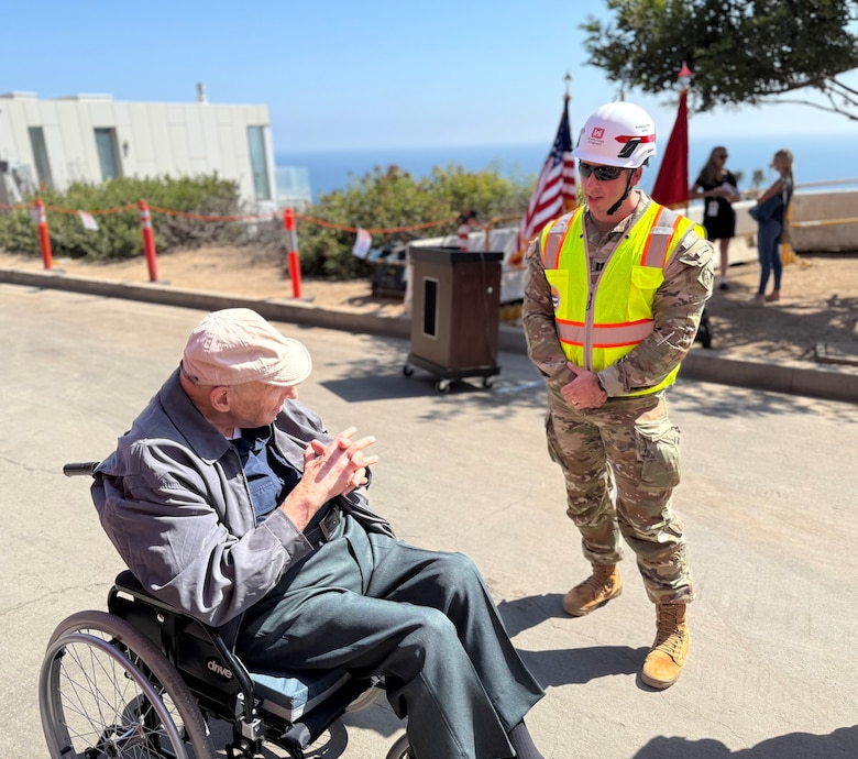Capt. Zachary Bailey, with the U.S. Army Corps of Engineers Recovery Field Office, talks with Noland West, whose property was the last opt-in private property slated for debris removal, during a milestone event Aug. 26 in the Pacific Palisades neighborhood of Los Angeles.