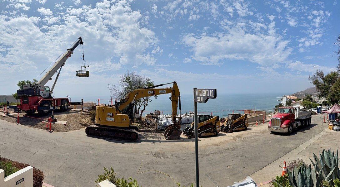 In this panoramic view of Tramonto Drive in the Pacific Palisades neighborhood of Los Angeles, several properties can be seen Aug. 26 undergoing debris removal operations.