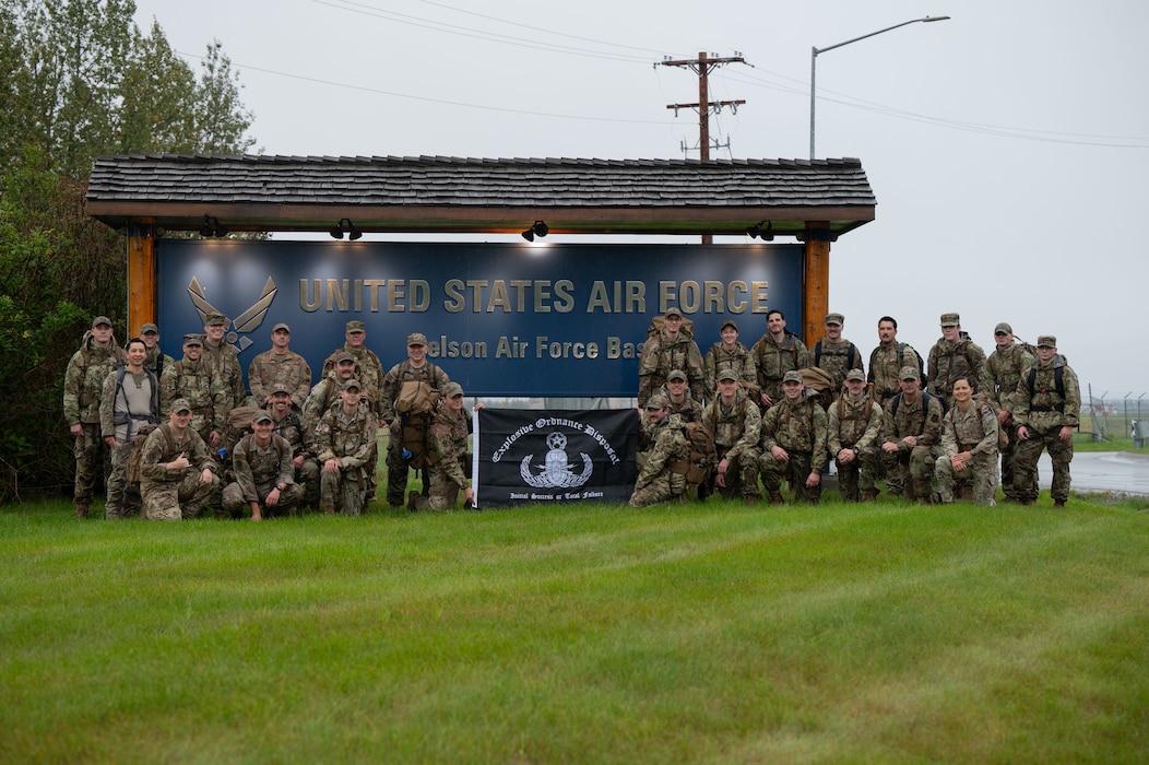Airmen assigned to the 354th Civil Engineer Squadron pose in front of the base entrance sign at Eielson Air Force Base, Alaska, Sept. 5, 2025.