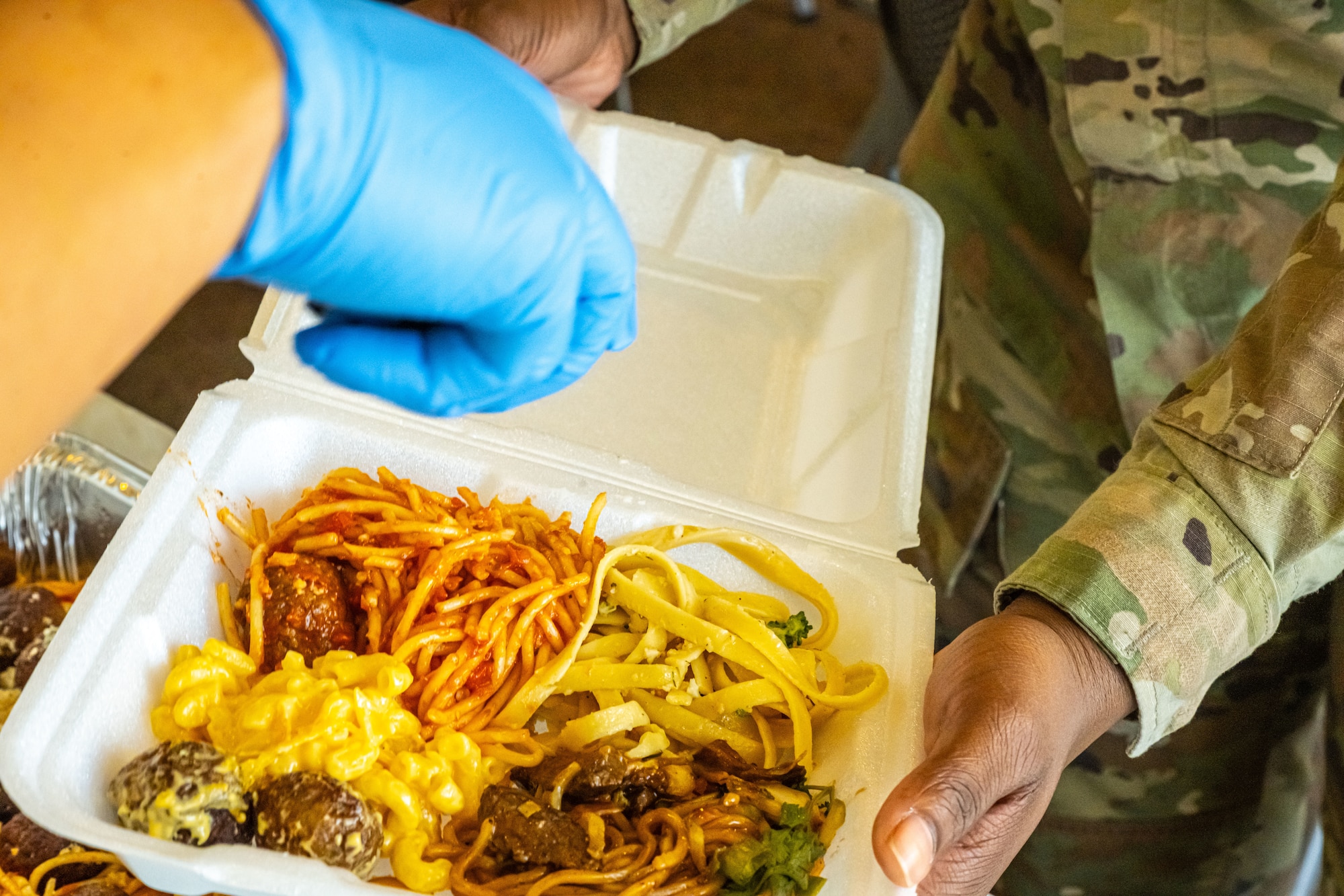 An Airman receives food during the monthly dorm dinner at Minot Air Force Base, North Dakota, Sep. 5, 2025. Dorm dinners provide free meals and a social environment for Airmen in the dorms.
