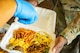 An Airman receives food during the monthly dorm dinner at Minot Air Force Base, North Dakota, Sep. 5, 2025. Dorm dinners provide free meals and a social environment for Airmen in the dorms.