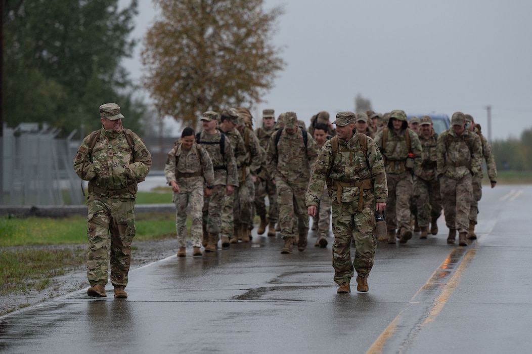 U.S. Air Force Col. Timothy Foster, 354th Maintenance Group commander, front left, and Chief Master Sergeant Matthew Perry, 354th Maintenance Group senior enlisted leader, front right, march in the 11th Annual Explosive Ordinance Disposal Memorial Ruck at Eielson Air Force Base, Alaska, Sept. 5, 2025.