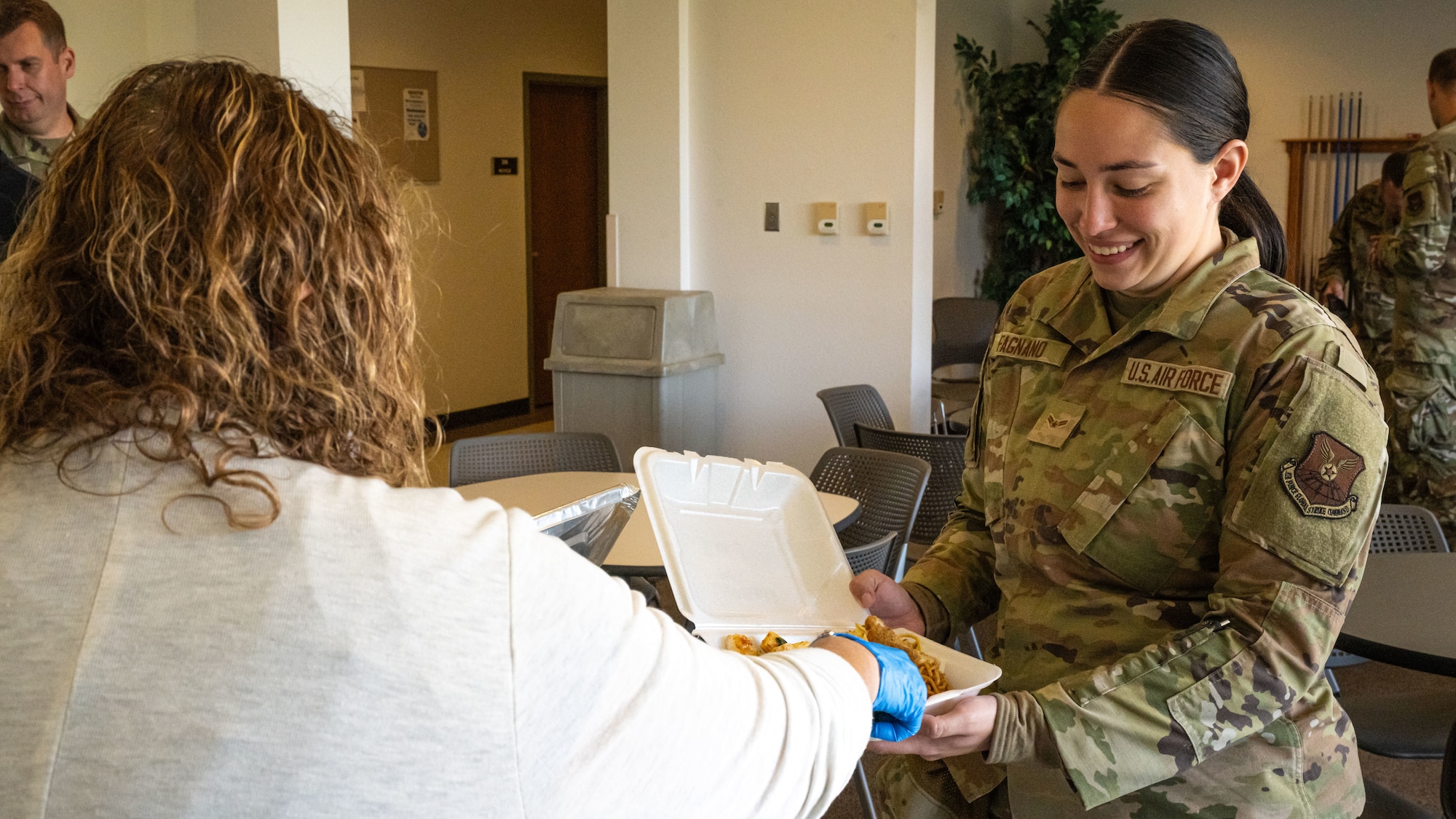 Sharian Fagnano, 5th Bomb Wing Chapel Corps religious affairs apprentice, receives food during the monthly dorm dinner at Minot Air Force Base, North Dakota, Sep. 5, 2025. The dorm dinner is a monthly event put on by the Minot Chapel team and is facilitated by volunteer organizations and clubs for Airmen living in the dorms.