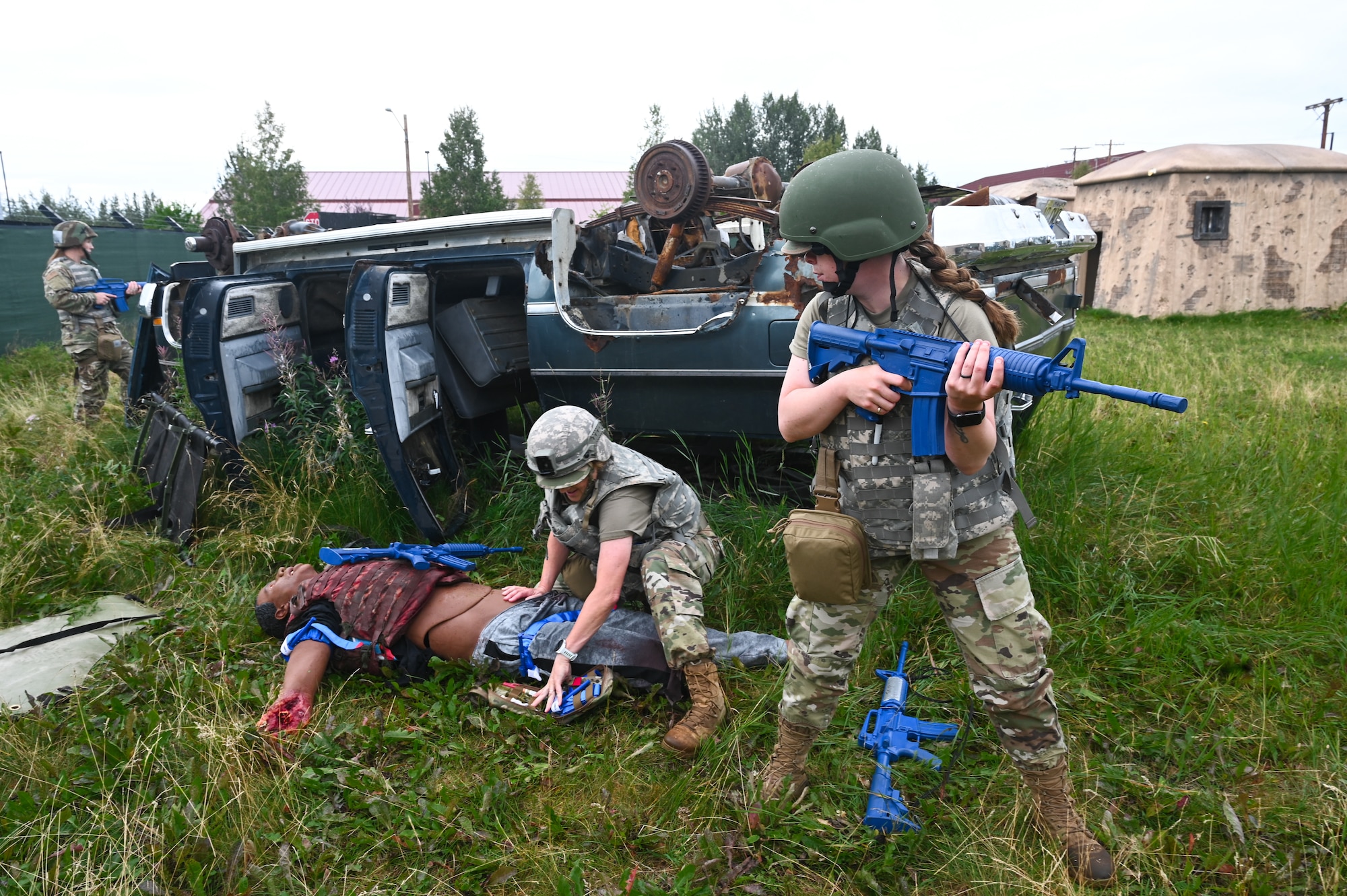 A team of Tactical Combat Casualty Care (TCCC) students conduct emergency medical care and security during an exercise at Fort Wainwright, Alaska.