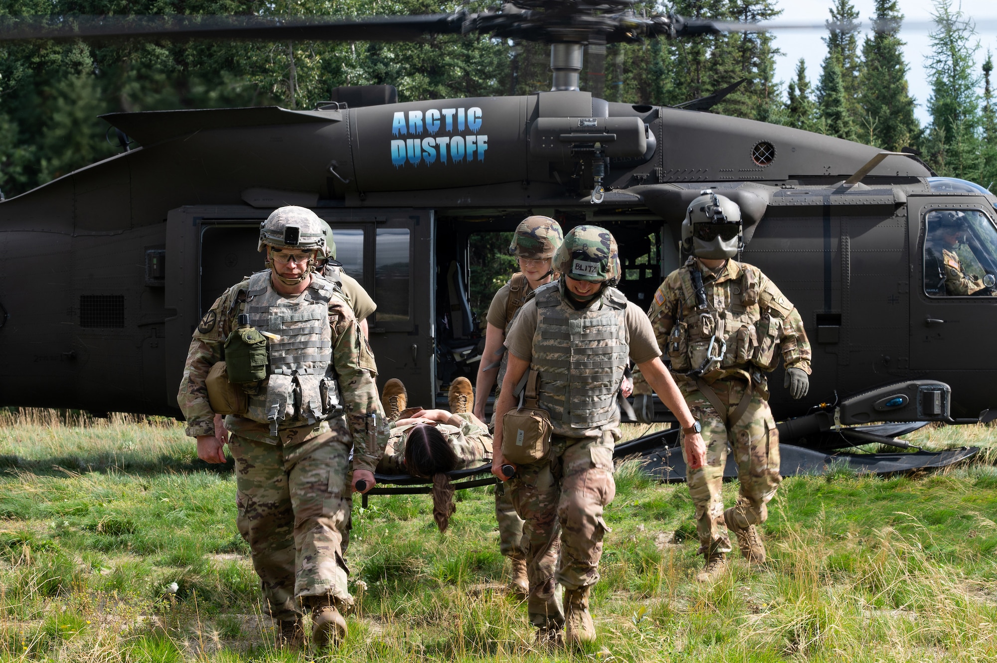 "Tactical Combat Casualty Care (TCCC) students from the 168th Wing train on loading and offloading patients from a UH-60 Black Hawk helicopter during an advanced Tactical Combat Casualty Care training at Fort Wainwright, Alaska.