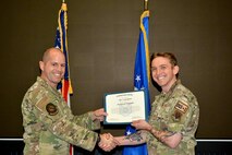 U.S. Air Force Tech. Sgt. Ty LaCourse, 48th Intelligence Support Squadron cyber poses with a certificate during a promotion ceremony at Beale Air Force Base, California, February 1, 2025.