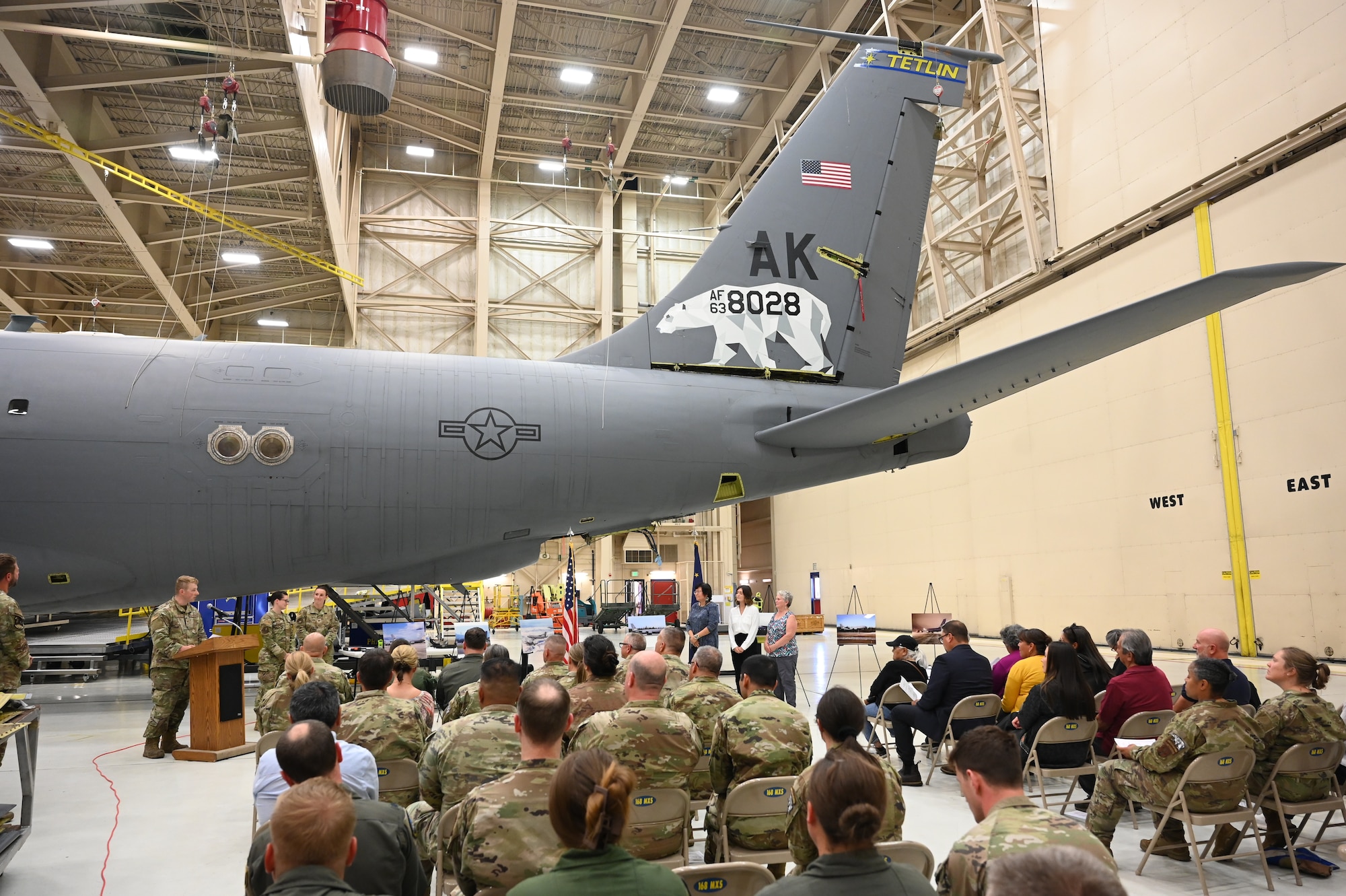 Representatives from Gwichyaa Zhee were presented with prints of the Alaska Air National Guard's KC-135 aircraft with the village's tail flash during the naming ceremony at Eielson Air Force Base on July 31, 2025.