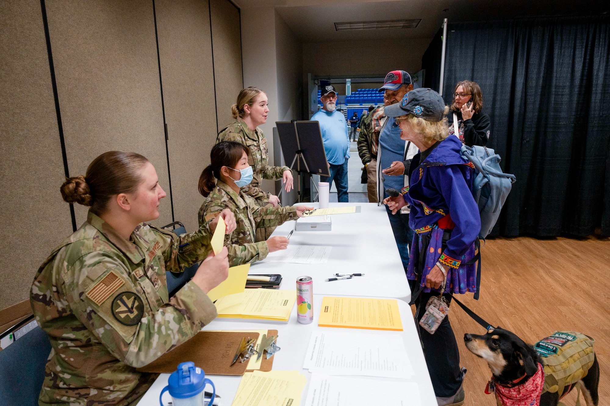 U.S. Air National Guard Tech. Sgt. Jazzmin Tristan, Tech. Sgt. Yao Cai, and Senior Airman Jillian Dominguez check in patients for medical and dental services provided by the Alaska Air National Guard during the 2025 Fairbanks Veterans Stand Down at the Carlson Center in Fairbanks, Alaska.