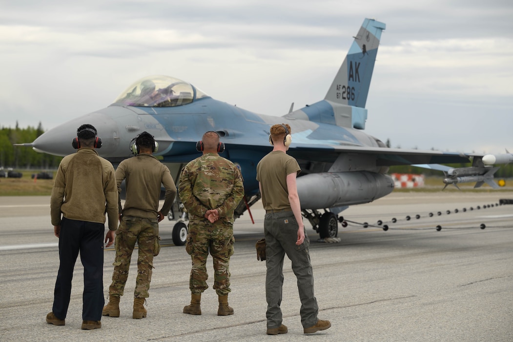 U.S. Air Force Airmen from the 18th Fighter Generation Squadron observe an F-16 Fighting Falcon after an Aircraft Arresting System test at Eielson Air Force Base, Alaska, May 29, 2025.