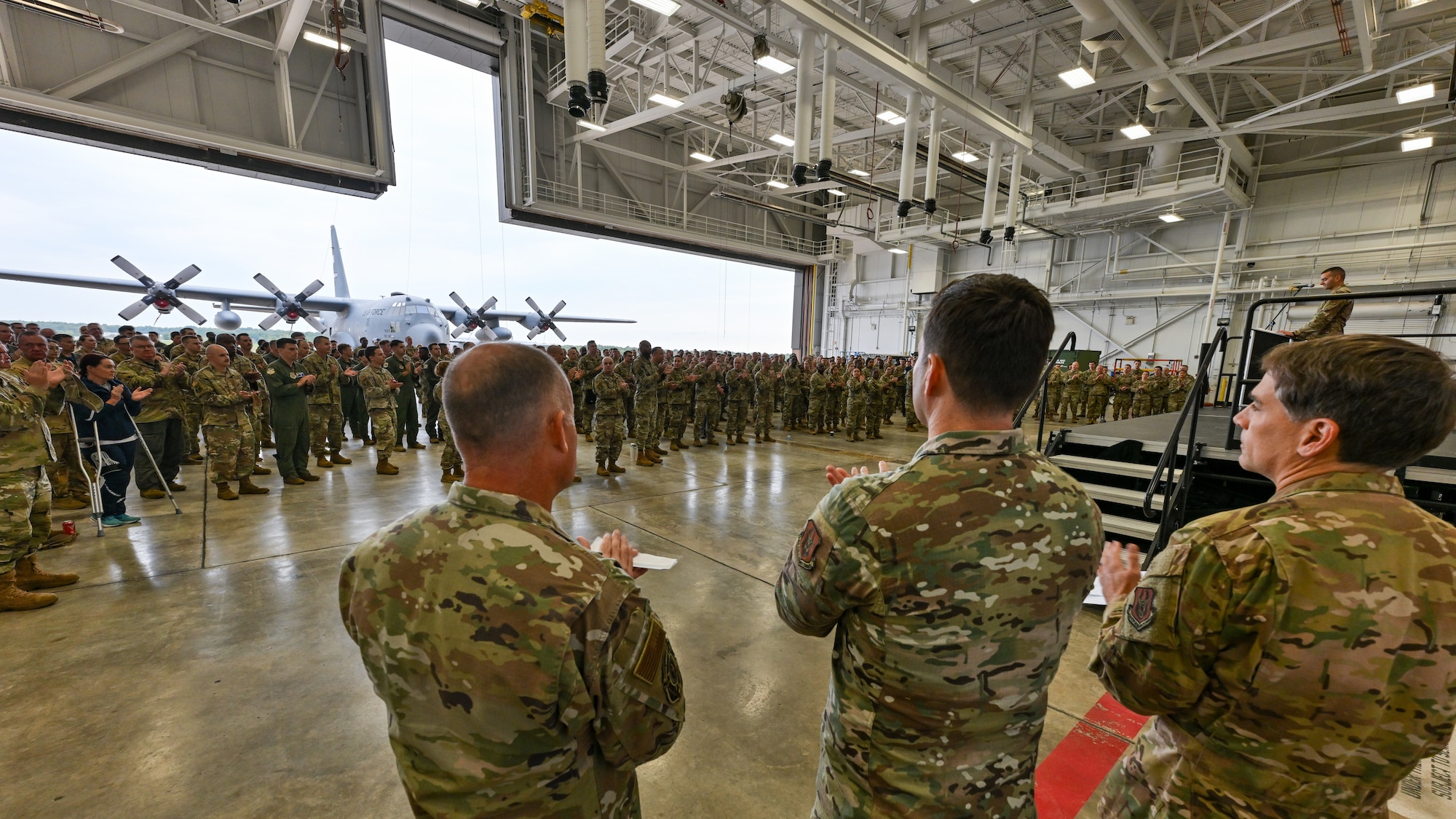 Reserve Airmen of the 910th Airlift Wing applaud as Capt. Donnie Hatheway, 910th Airlift Wing chief of public affairs, shares the Wing’s Air Force and Air Force Reserve Command-level accomplishments of 2024 during a commander’s call, Sept. 6, 2025, at Youngstown Air Reserve Station, Ohio.