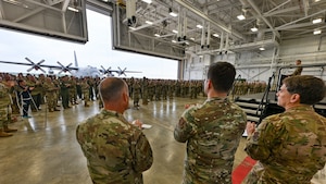 Reserve Airmen of the 910th Airlift Wing applaud as Capt. Donnie Hatheway, 910th Airlift Wing chief of public affairs, shares the Wing’s Air Force and Air Force Reserve Command-level accomplishments of 2024 during a commander’s call, Sept. 6, 2025, at Youngstown Air Reserve Station, Ohio.