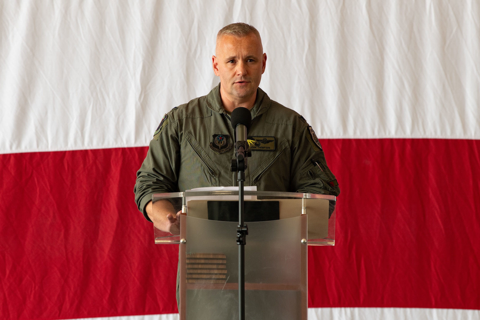 an uniformed man stands at a podium