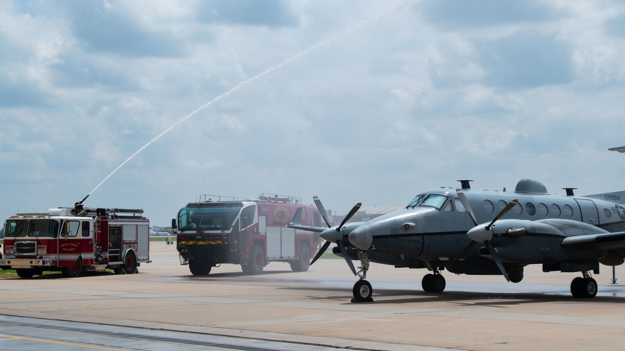 a fire truck sprays water on an aircraft