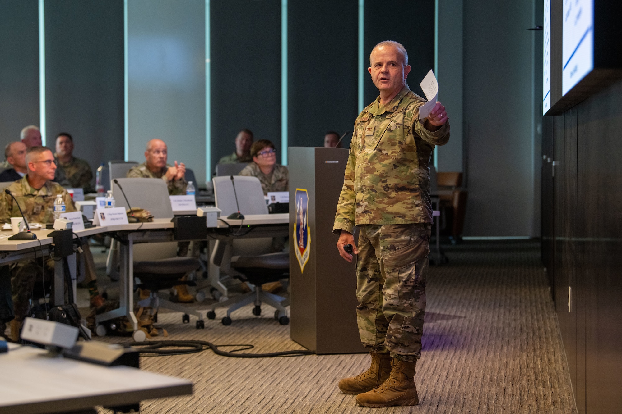 an uniformed man presents to other uniformed members