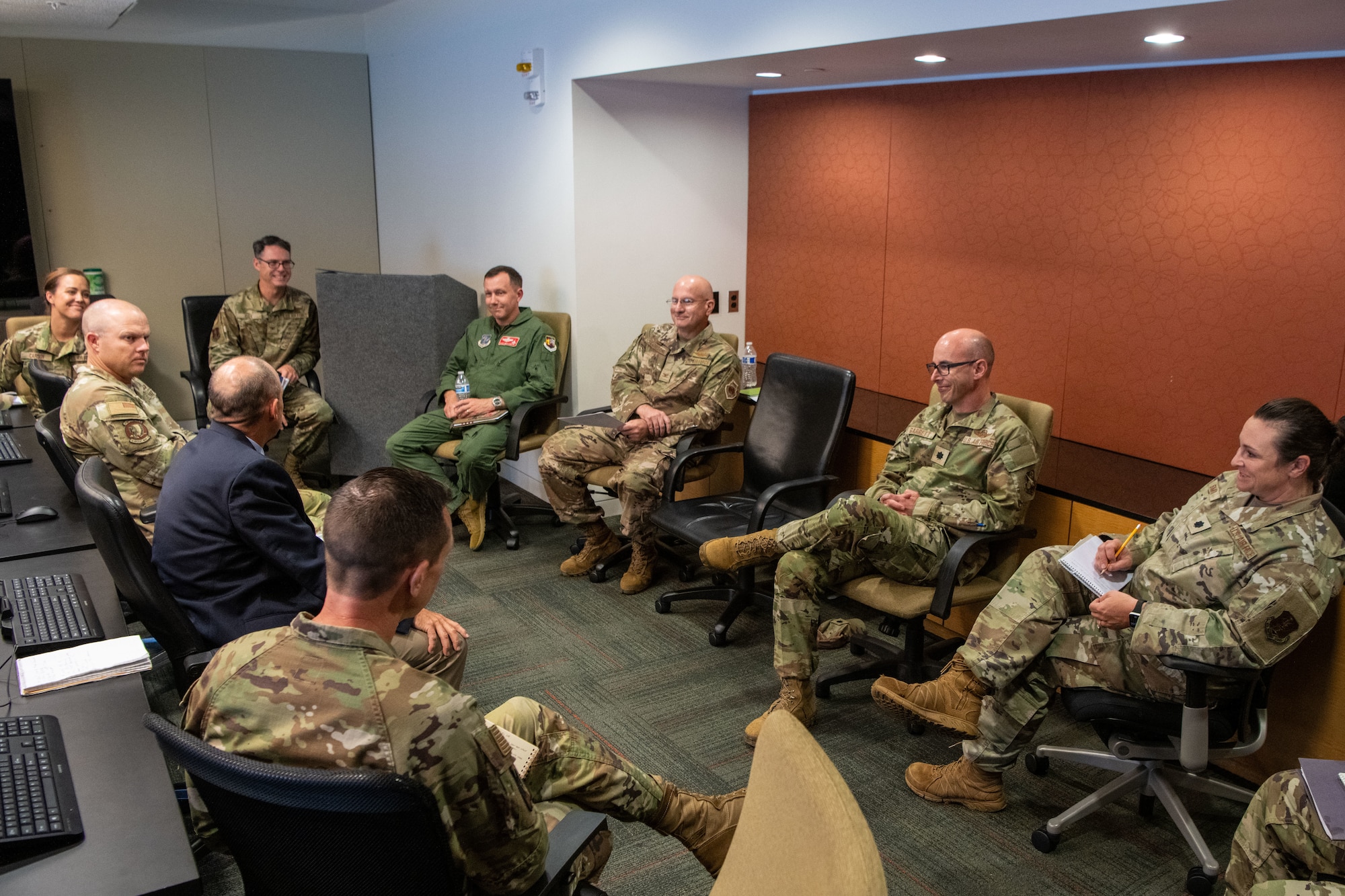 uniformed members sit in a circle to discuss objectives