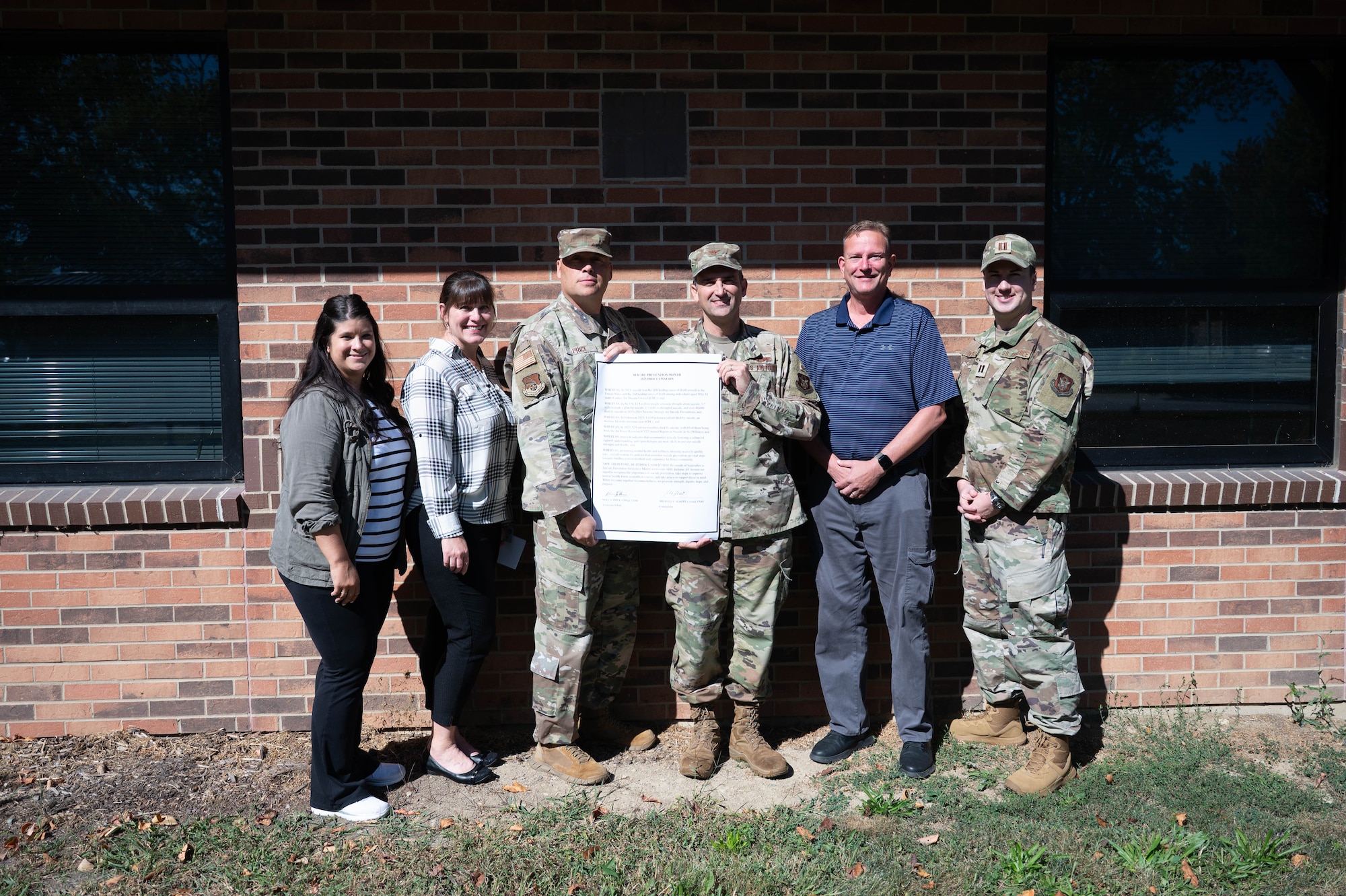 434th ARW commander and 434th ARW command Chief stand with Integrated Prevention & Resilience Office with signed Suicide Prevention Month proclamation