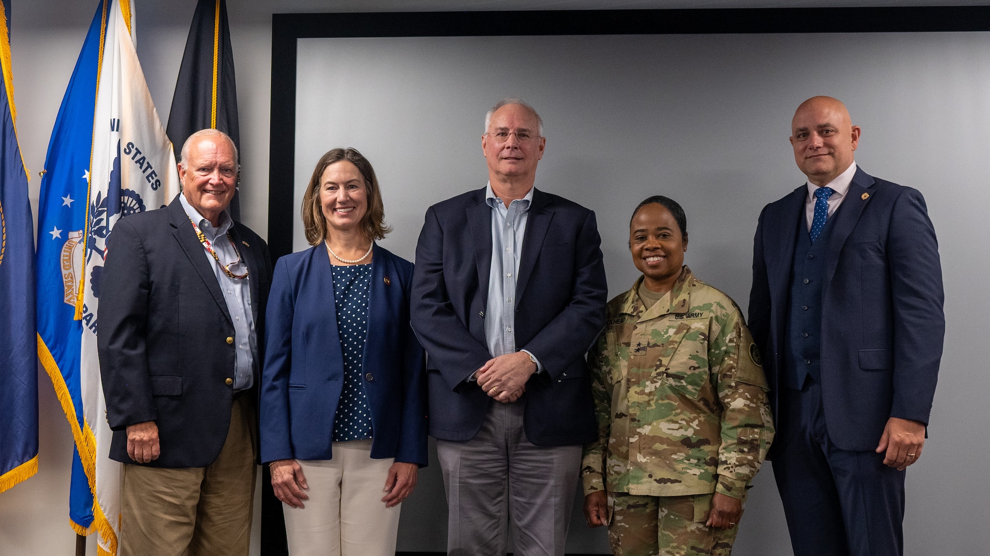 Russell J. Strickland, secretary of Maryland Department of Emergency Management (L to R), Maryland state senator Katie Fry Hester, District 9, John Garstka, director for Cyber Warfare within the Office of the Deputy Assistant Secretary of Defense for Platform and Weapon Portfolio Management, Maryland Army National Guard Maj. Gen. Janeen L. Birckhead, adjutant general of Maryland, and Adam R. Flasch (Brig. Gen., U.S. Army, retired), deputy chief of staff for Public Safety & Homeland Security, pose for a group photo during the second day of the State of Maryland Critical Infrastructure Cyber Resilience Workshop at the Technology Advancement Center in Columbia, Maryland, August 27, 2025. The Maryland Critical Infrastructure Cyber Resilience Workshop, which focused on the water and wastewater sector during the three-day event, was co-organized by the Office of the Under Secretary of Defense for Acquisition and Sustainment Cyber Warfare Directorate, the Maryland National Guard, and the state of Maryland. (U.S. Air National Guard Photo by Airman 1st Class Sarah Hoover)