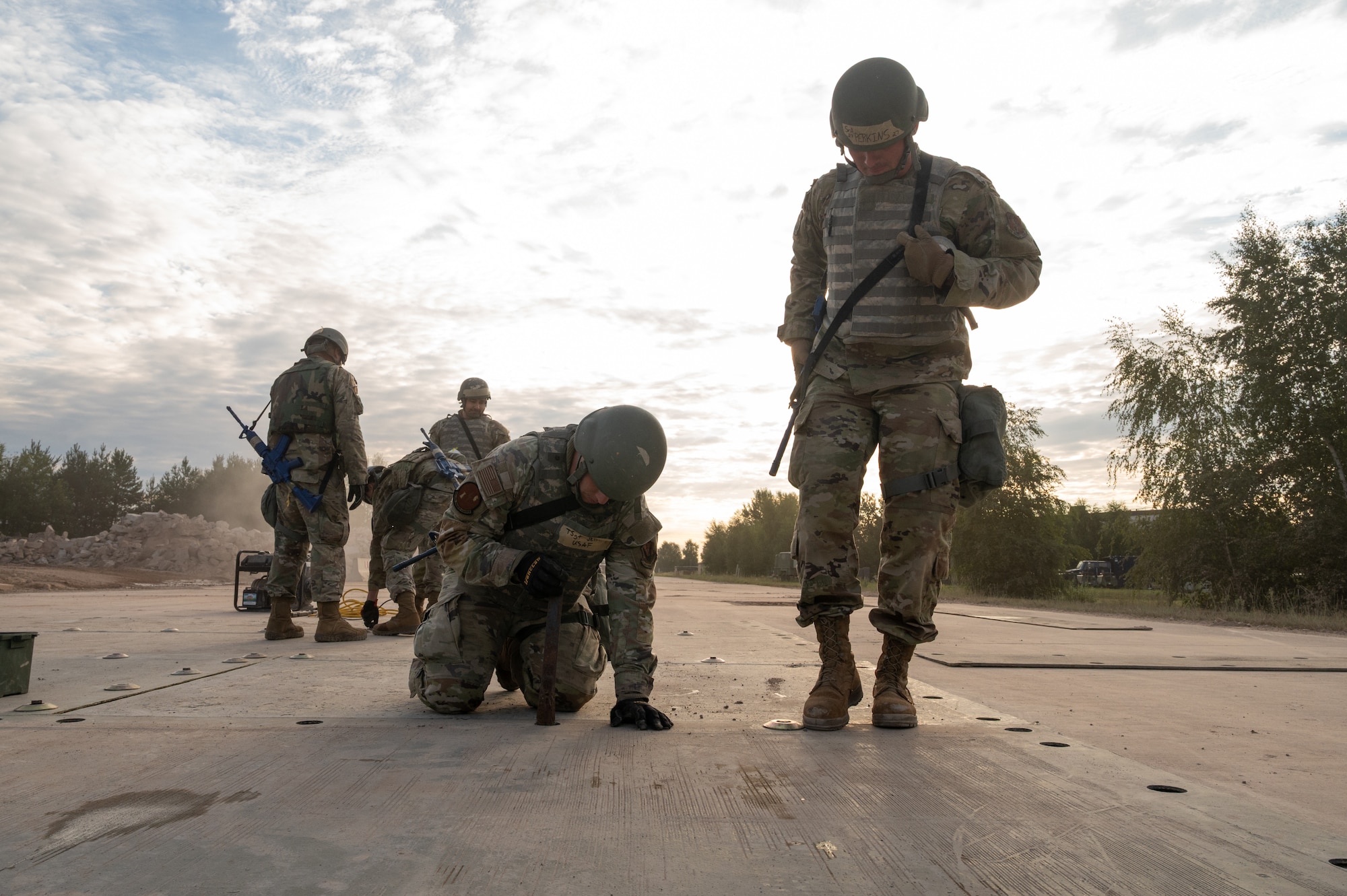 Airmen of the 155th Civil Engineer Squadron, alongside active duty counterparts, assemble fiber reinforced polymer matting as part of a training exercise at Ramstein Air Base, Germany, Aug. 7, 2025.