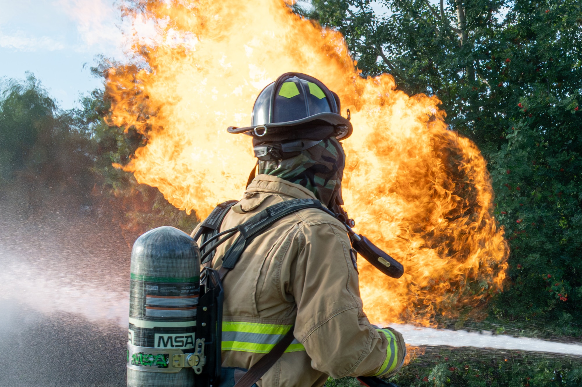 Firefighters assigned to the 155th Civil Engineer Squadron, extinguish a simulated aircraft fire as part of a training exercise at Ramstein Air Base, Germany, Aug. 8, 2025.