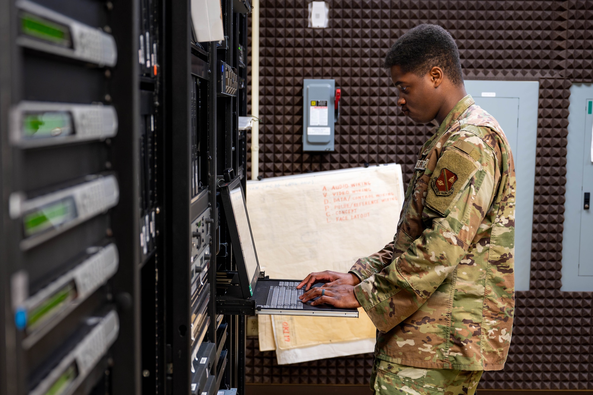 U.S. Air Force Staff Sgt. Alexander Parris, AFN Okinawa noncommissioned officer in charge of broadcast maintenance, inspects broadcast servers at Camp Foster, Japan, Sept. 2, 2025. The tech control facility serves as the backbone of AFN Okinawa’s operations, ensuring broadcasts run smoothly through constant monitoring and precision troubleshooting. (U.S. Air Force photo by Airman Nathaniel Jackson)