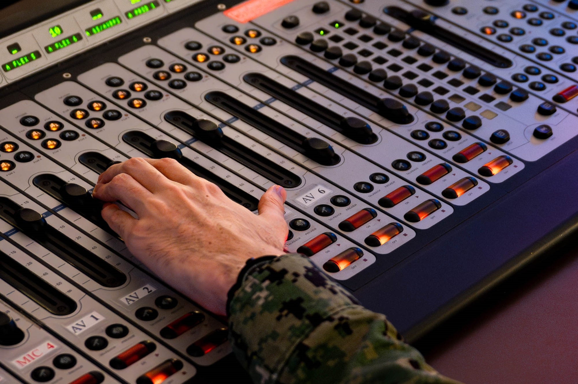 U.S. Navy Mass Communications Seaman Tyler Jackson, AFN Okinawa DJ, adjusts the sound board inside the broadcasting studio at Camp Foster, Japan, Sept. 2, 2025. AFN Okinawa supports the military community by providing timely information and entertainment across multiple platforms. U.S. Air Force photo by Airman Nathaniel Jackson)
