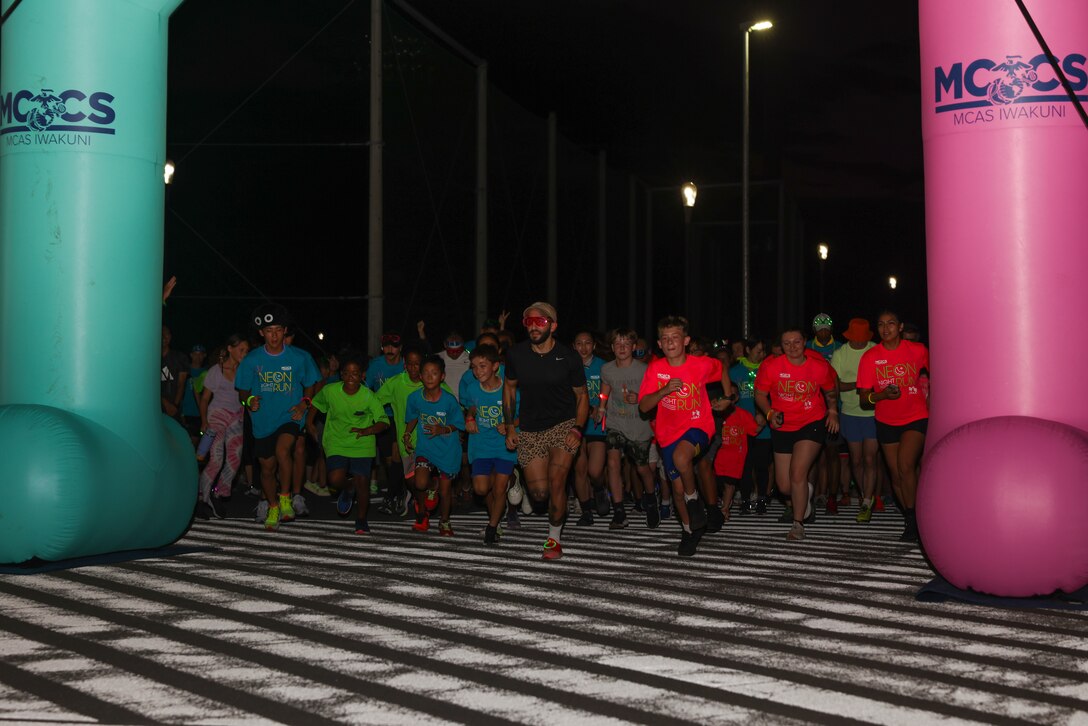Participants begin running the Marine Corps Air Station Iwakuni 2025 Neon Night Run at the Atago Sports Complex, Iwakuni, Japan, Aug. 22, 2025. The 2025 Neon Night Run, hosted by Marine Corps Community Services, consisted of warm-up Zumba dancing, a 2.7K family fun run, and raffle drawings for various prizes. (U.S. Marine Corps photo by Lance Cpl. Isaac De Leon)