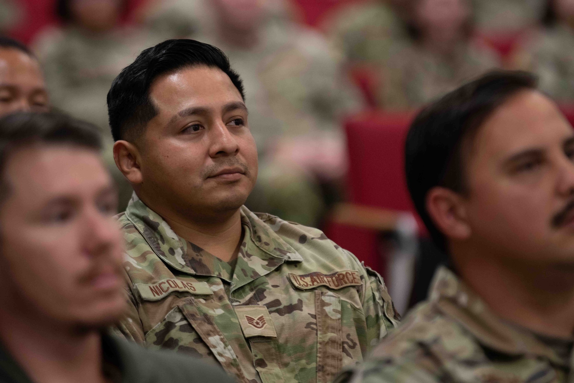 military members sits during ceremony