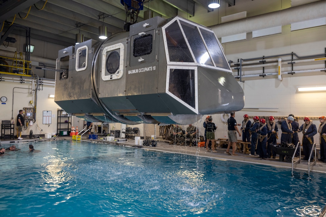 U.S. Marines from across II Marine Expeditionary Force prepare to execute underwater egress training (UET) at Marine Corps Base Camp Lejeune, North Carolina, Aug. 26, 2025. UET provides service members with the knowledge, skills, and abilities to safely egress a submerged aircraft. (U.S. Marine Corps Photo by Cpl. Marc Imprevert)